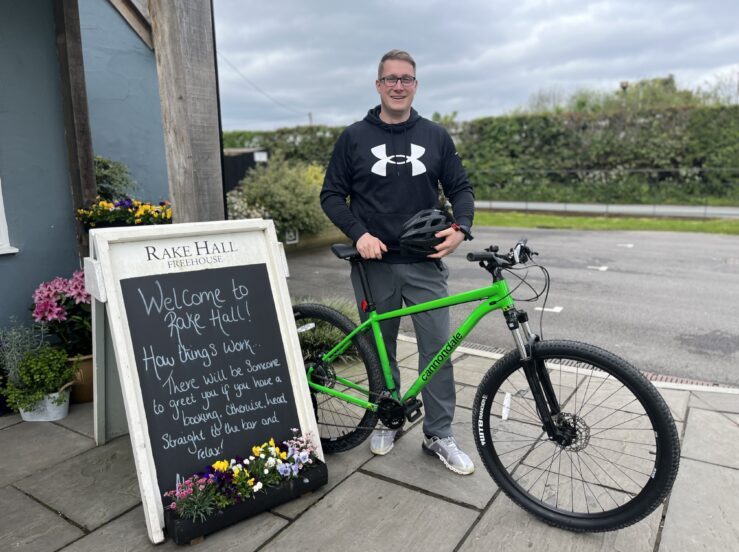 Brunning & Price Team Member Rob holding a green bike to advocate their Cycle to Work scheme