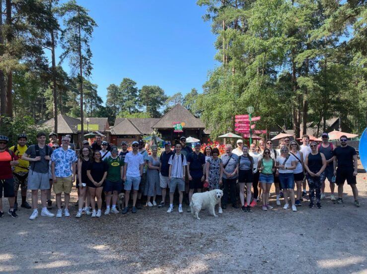 Several Brunning & Price Team Members standing in a long line posing for a photo on one of their Wellness Walks